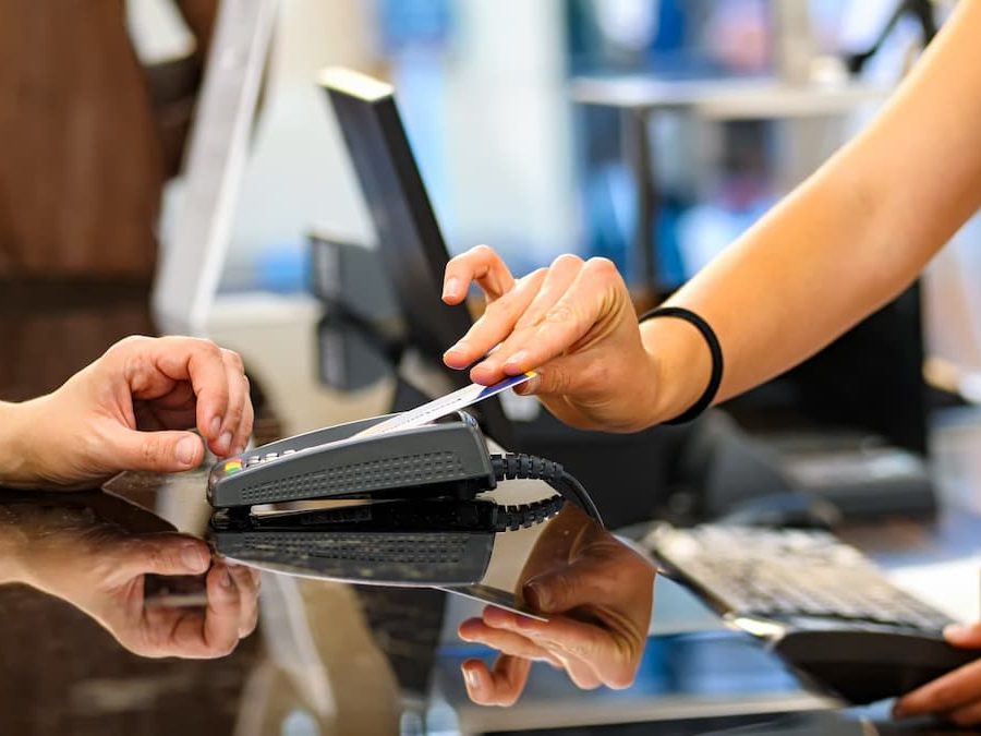 Woman pays by credit card with contactless technology.